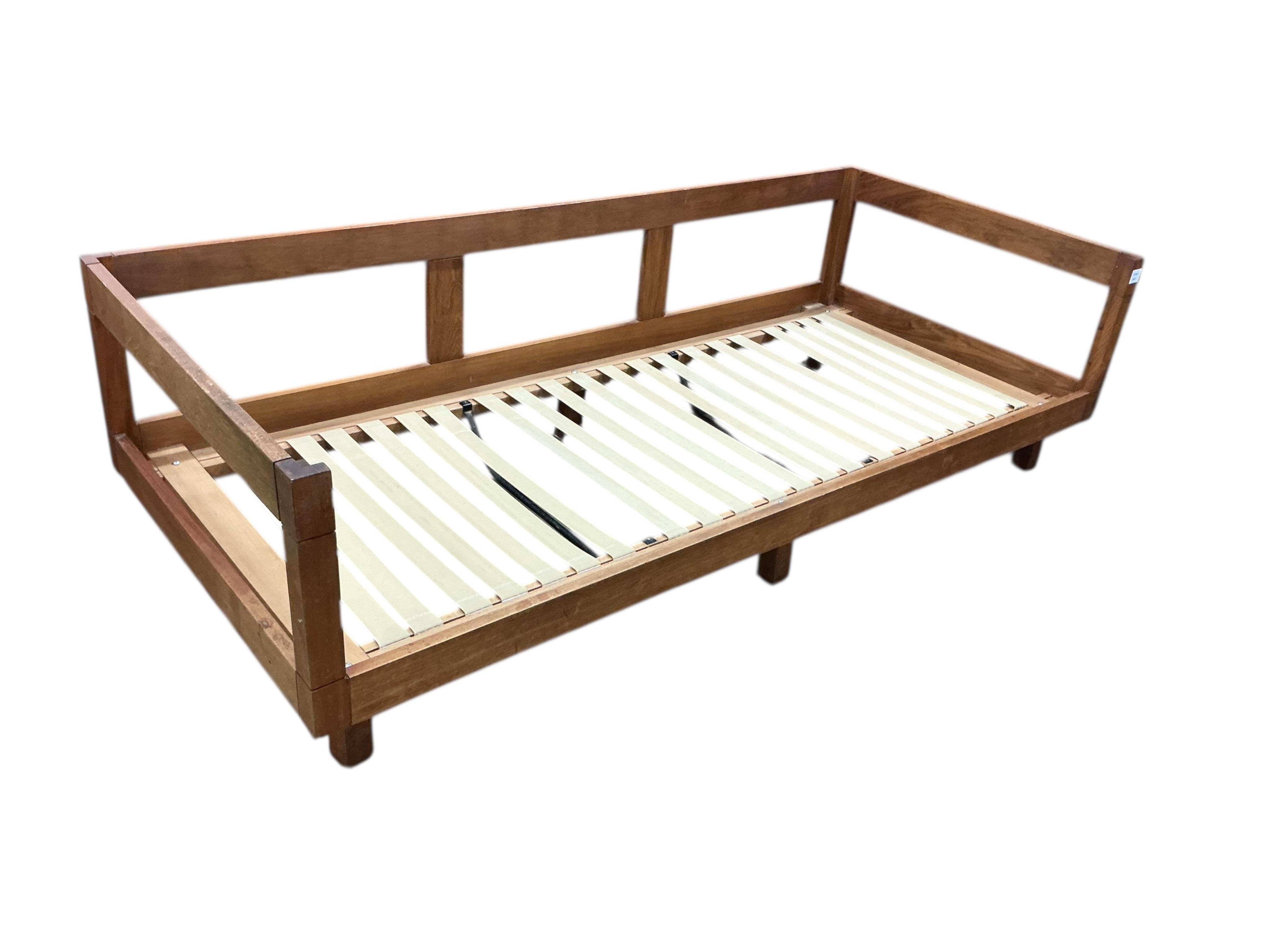 A mid century teak Bastiano style three seater settee, width 199cm, depth 86cm, height 84cm